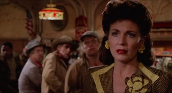 Movie still from “Who Framed Roger Rabbit” (1988), directed by Robert Zemeckis – A group of people standing around a woman in front of a building; Close Up shot, Over the shoulder angle