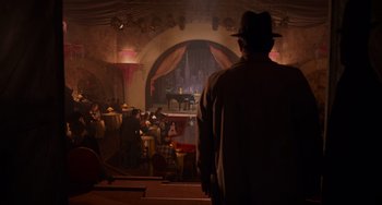Movie still from “Who Framed Roger Rabbit” (1988), directed by Robert Zemeckis – A man wearing a hat standing in front of an audience; Wide shot, High angle