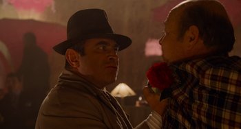 Movie still from “Who Framed Roger Rabbit” (1988), directed by Robert Zemeckis – A man wearing a hat holding a red rose in his hand; Close Up shot, Over the shoulder angle