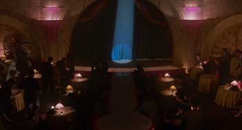 Movie still from “Who Framed Roger Rabbit” (1988), directed by Robert Zemeckis – People sitting at tables in front of a stage; Extreme Wide shot, High angle