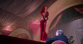 Movie still from “Who Framed Roger Rabbit” (1988), directed by Robert Zemeckis – A woman in a red dress standing in front of a man; Medium shot, Low angle
