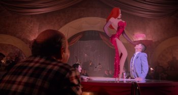 Movie still from “Who Framed Roger Rabbit” (1988), directed by Robert Zemeckis – A woman in a red dress on a stage; Wide shot, Over the shoulder angle