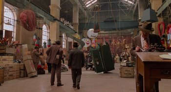 Movie still from “Who Framed Roger Rabbit” (1988), directed by Robert Zemeckis – Two men in suits are walking through a building; Extreme Wide shot, High angle