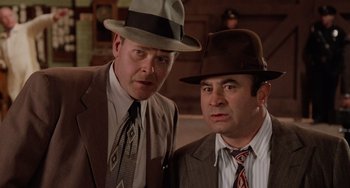 Movie still from “Who Framed Roger Rabbit” (1988), directed by Robert Zemeckis – A couple of men wearing hats and suits; Close Up shot, Low angle