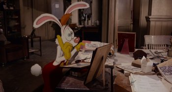 Movie still from “Who Framed Roger Rabbit” (1988), directed by Robert Zemeckis – A painting of a rabbit sitting in front of an easel; Medium shot, High angle