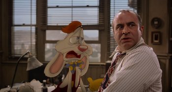 Movie still from “Who Framed Roger Rabbit” (1988), directed by Robert Zemeckis – A man standing in front of an animated character; Medium shot, Over the shoulder angle