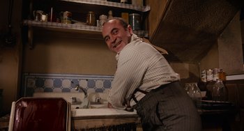 Movie still from “Who Framed Roger Rabbit” (1988), directed by Robert Zemeckis – A man leaning over a sink in a kitchen; Medium shot, High angle