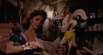 Movie still from “Who Framed Roger Rabbit” (1988), directed by Robert Zemeckis – A woman sitting next to an animated rabbit; Medium shot, Over the shoulder angle