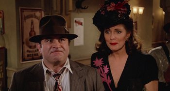 Movie still from “Who Framed Roger Rabbit” (1988), directed by Robert Zemeckis – A man and a woman wearing hats and suits; Close Up shot, Low angle