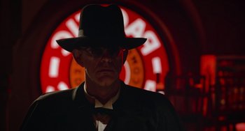 Movie still from “Who Framed Roger Rabbit” (1988), directed by Robert Zemeckis – A man wearing a hat and a suit and tie; Close Up shot, Low angle