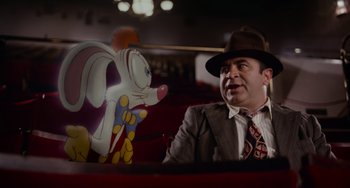 Movie still from “Who Framed Roger Rabbit” (1988), directed by Robert Zemeckis – A man sitting next to an animated rabbit; Medium shot, Over the shoulder angle