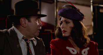 Movie still from “Who Framed Roger Rabbit” (1988), directed by Robert Zemeckis – A man and a woman wearing hats and a red dress; Close Up shot, Over the shoulder angle