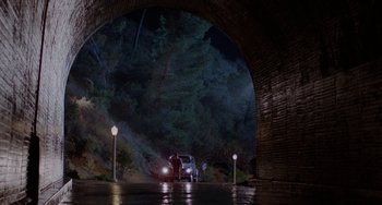 Movie still from “Who Framed Roger Rabbit” (1988), directed by Robert Zemeckis – A car is parked under a bridge at night; Extreme Wide shot, Low angle