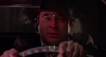 Movie still from “Who Framed Roger Rabbit” (1988), directed by Robert Zemeckis – A man wearing a hat driving in a car at night; Close Up shot, Low angle