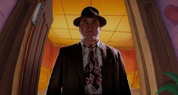 Movie still from “Who Framed Roger Rabbit” (1988), directed by Robert Zemeckis – A man in a suit and tie standing in a room; Medium shot, Low angle