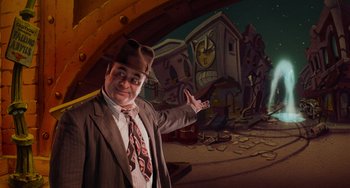 Movie still from “Who Framed Roger Rabbit” (1988), directed by Robert Zemeckis – A man wearing a hat and a suit points to a building; Wide shot, Over the shoulder angle