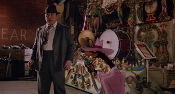 Movie still from “Who Framed Roger Rabbit” (1988), directed by Robert Zemeckis – A man in a suit standing next to an animated character; Wide shot, Over the shoulder angle