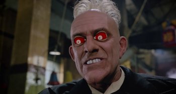 Movie still from “Who Framed Roger Rabbit” (1988), directed by Robert Zemeckis – An old man wearing a black shirt with red eyes and white hair; Close Up shot, Low angle