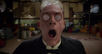Movie still from “Who Framed Roger Rabbit” (1988), directed by Robert Zemeckis – A person wearing a mask with eyes wide open; Close Up shot, Low angle