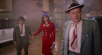Movie still from “Who Framed Roger Rabbit” (1988), directed by Robert Zemeckis – A woman in a red dress and a man in a blue suit and a hat; Medium shot, Over the shoulder angle