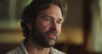 Movie still from “Wild Life” (2023), directed by Jimmy Chin – A person with a beard; Close Up shot, Low angle