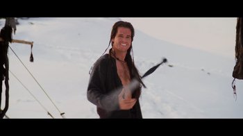 Movie still from “Willow: Behind the Magic” (2023), directed by Adam Countee – A man with long black hair holding a pair of ski poles; Medium shot, Over the shoulder angle