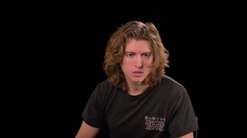 Movie still from “Willow: Behind the Magic” (2023), directed by Adam Countee – A man with long hair and a black t - shirt; Close Up shot, Low angle