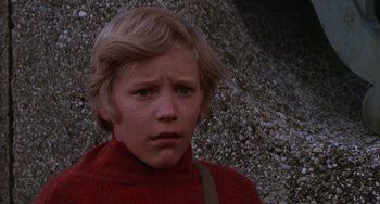 Movie still from “Willy Wonka & the Chocolate Factory” (1971), directed by Mel Stuart – A young boy in a red sweater looking at the camera; Close Up shot, Low angle