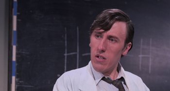 Movie still from “Willy Wonka & the Chocolate Factory” (1971), directed by Mel Stuart – A man in a white dress shirt and tie; Close Up shot, Over the shoulder angle