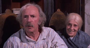 Movie still from “Willy Wonka & the Chocolate Factory” (1971), directed by Mel Stuart – An older man and a younger woman sitting next to each other; Close Up shot, High angle