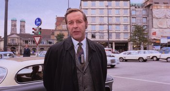 Movie still from “Willy Wonka & the Chocolate Factory” (1971), directed by Mel Stuart – A man standing in the middle of a street; Medium shot, Low angle