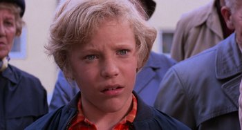 Movie still from “Willy Wonka & the Chocolate Factory” (1971), directed by Mel Stuart – A person with a person in the background; Close Up shot, High angle