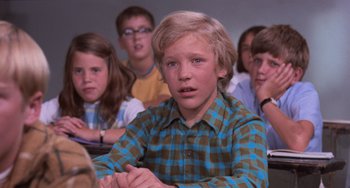 Movie still from “Willy Wonka & the Chocolate Factory” (1971), directed by Mel Stuart – A group of children sitting in a classroom; Close Up shot, High angle