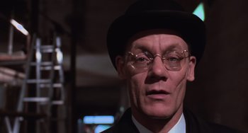 Movie still from “Willy Wonka & the Chocolate Factory” (1971), directed by Mel Stuart – A person wearing glasses and a hat; Close Up shot, Low angle