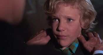 Movie still from “Willy Wonka & the Chocolate Factory” (1971), directed by Mel Stuart – A young man with blonde curly hair wearing a plaid shirt; Close Up shot, Over the shoulder angle