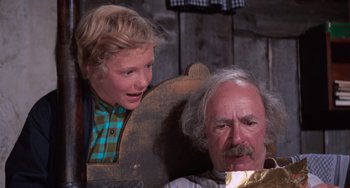 Movie still from “Willy Wonka & the Chocolate Factory” (1971), directed by Mel Stuart – An older man sitting next to a young boy; Close Up shot, Low angle