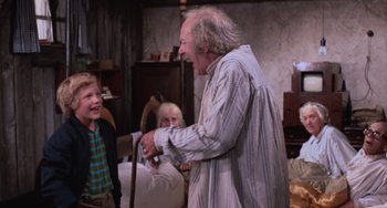 Movie still from “Willy Wonka & the Chocolate Factory” (1971), directed by Mel Stuart – An older man and a young boy in a living room; Medium shot, Over the shoulder angle