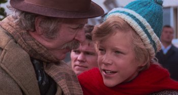 Movie still from “Willy Wonka & the Chocolate Factory” (1971), directed by Mel Stuart – An older man and a young boy are talking to each other; Close Up shot, Over the shoulder angle