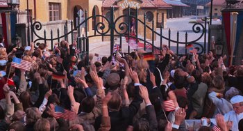 Movie still from “Willy Wonka & the Chocolate Factory” (1971), directed by Mel Stuart – A crowd of people standing in front of a gate; Wide shot, High angle