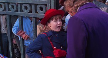 Movie still from “Willy Wonka & the Chocolate Factory” (1971), directed by Mel Stuart – A young girl in a red hat and gloves talking to an older woman; Medium shot, Over the shoulder angle