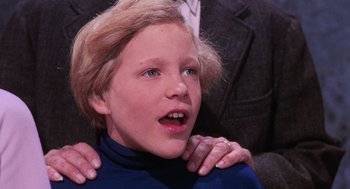 Movie still from “Willy Wonka & the Chocolate Factory” (1971), directed by Mel Stuart – A person with their hands on his shoulders; Close Up shot, Over the shoulder angle