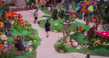 Movie still from “Willy Wonka & the Chocolate Factory” (1971), directed by Mel Stuart – People walking down a path in the middle of a garden; Extreme Wide shot, High angle