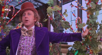 Movie still from “Willy Wonka & the Chocolate Factory” (1971), directed by Mel Stuart – A man dressed as willy wonka standing in front of a window; Medium shot, Low angle