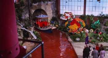 Movie still from “Willy Wonka & the Chocolate Factory” (1971), directed by Mel Stuart – A fake boat with a boat in the middle of a pond; Wide shot, High angle