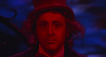 Movie still from “Willy Wonka & the Chocolate Factory” (1971), directed by Mel Stuart – A person wearing a top hat; Close Up shot, Low angle