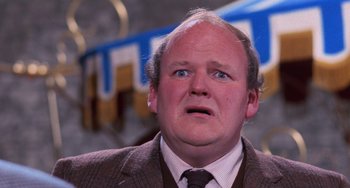 Movie still from “Willy Wonka & the Chocolate Factory” (1971), directed by Mel Stuart – A person wearing a suit and tie; Close Up shot, Low angle