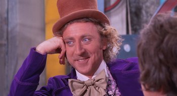Movie still from “Willy Wonka & the Chocolate Factory” (1971), directed by Mel Stuart – A person wearing a hat and a bow tie; Close Up shot, Over the shoulder angle