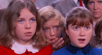 Movie still from “Willy Wonka & the Chocolate Factory” (1971), directed by Mel Stuart – A group of three young girls standing next to each other; Close Up shot, High angle