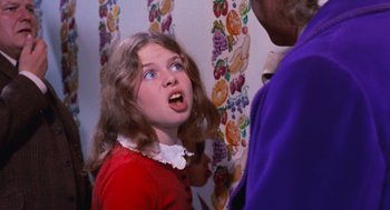 Movie still from “Willy Wonka & the Chocolate Factory” (1971), directed by Mel Stuart – A young girl with a surprised look on her face; Close Up shot, Over the shoulder angle