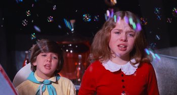 Movie still from “Willy Wonka & the Chocolate Factory” (1971), directed by Mel Stuart – Two young girls are blowing soap bubbles in a room; Close Up shot, Low angle